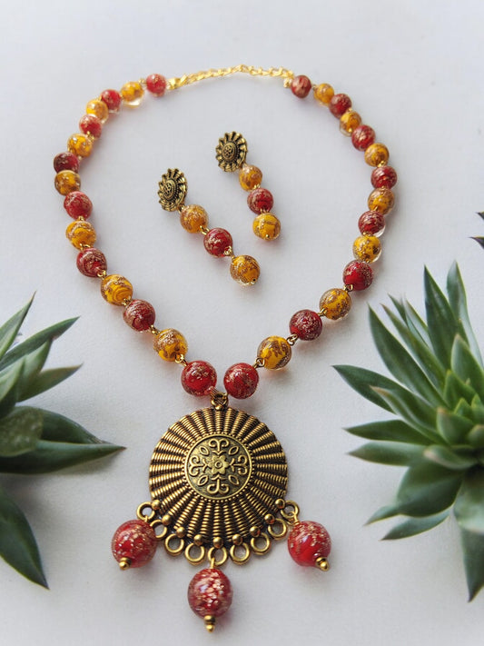 This stunning yellow and red jewelry set is the perfect accessory for Haldi / festive celebrations. Made for women, the set includes a metal pendant that adds a touch of elegance to any outfit. The vibrant colors of yellow and red make this set stand out, ensuring you'll be the center of attention. Whether you're dressing up for a special occasion or looking to add some color to your everyday wardrobe, this jewelry set is a must-have.