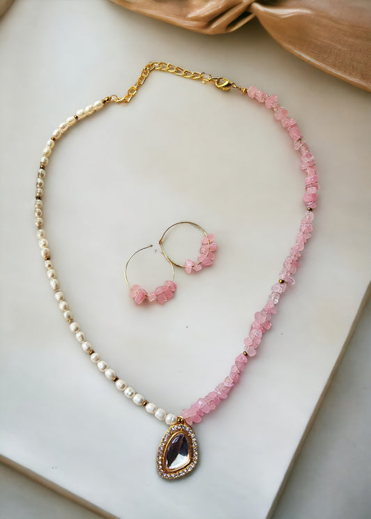 Enhance your appearance with our Pearl and pink chips jewelry set. This exquisite, handcrafted set is composed of lustrous pearls and half line pearl beads, featuring a striking design of half line pink uncut chip beads. The lightweight earrings complete the set, ideal for special occasions or as a considerate gift. Elevate any outfit with the grace and allure of this stunning set.