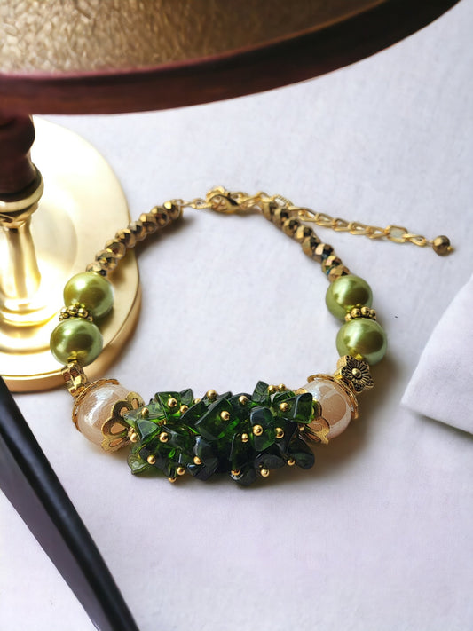 <p data-mce-fragment="1">Indulge in the exquisite beauty of our Bunch Green Bracelet. Handmade with chip beads, glass pearl, and golden accents, this bracelet exudes sophistication. The adjustable hook allows for a perfect fit, making it an elegant addition to any outfit. Experience luxury with every wear.</p>