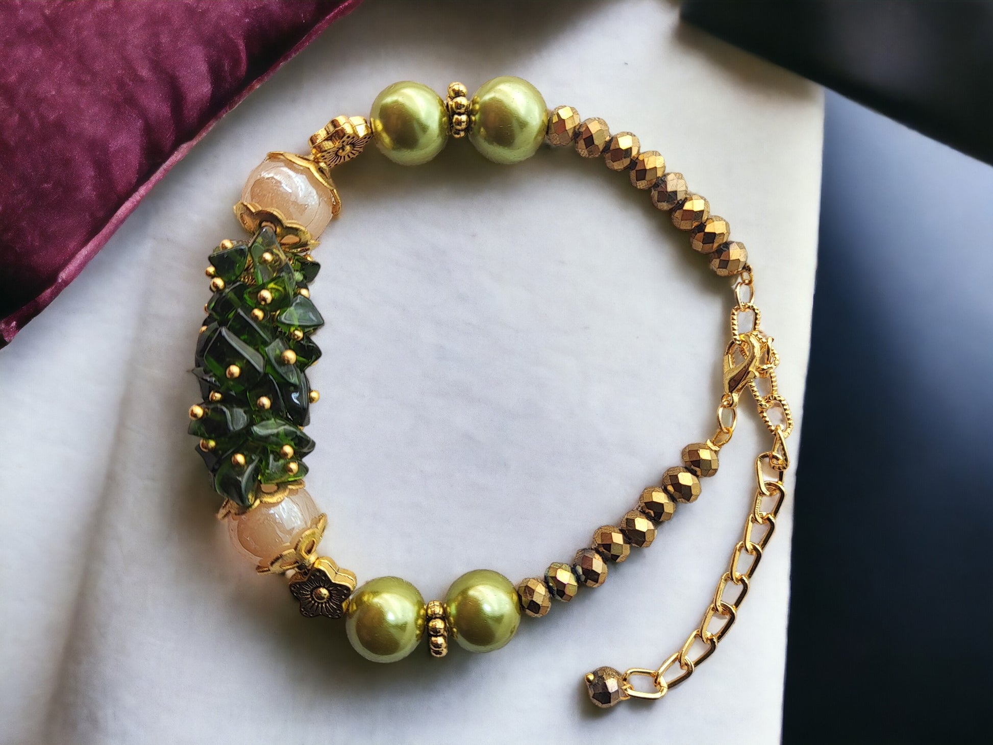<p data-mce-fragment="1">Indulge in the exquisite beauty of our Bunch Green Bracelet. Handmade with chip beads, glass pearl, and golden accents, this bracelet exudes sophistication. The adjustable hook allows for a perfect fit, making it an elegant addition to any outfit. Experience luxury with every wear.</p>