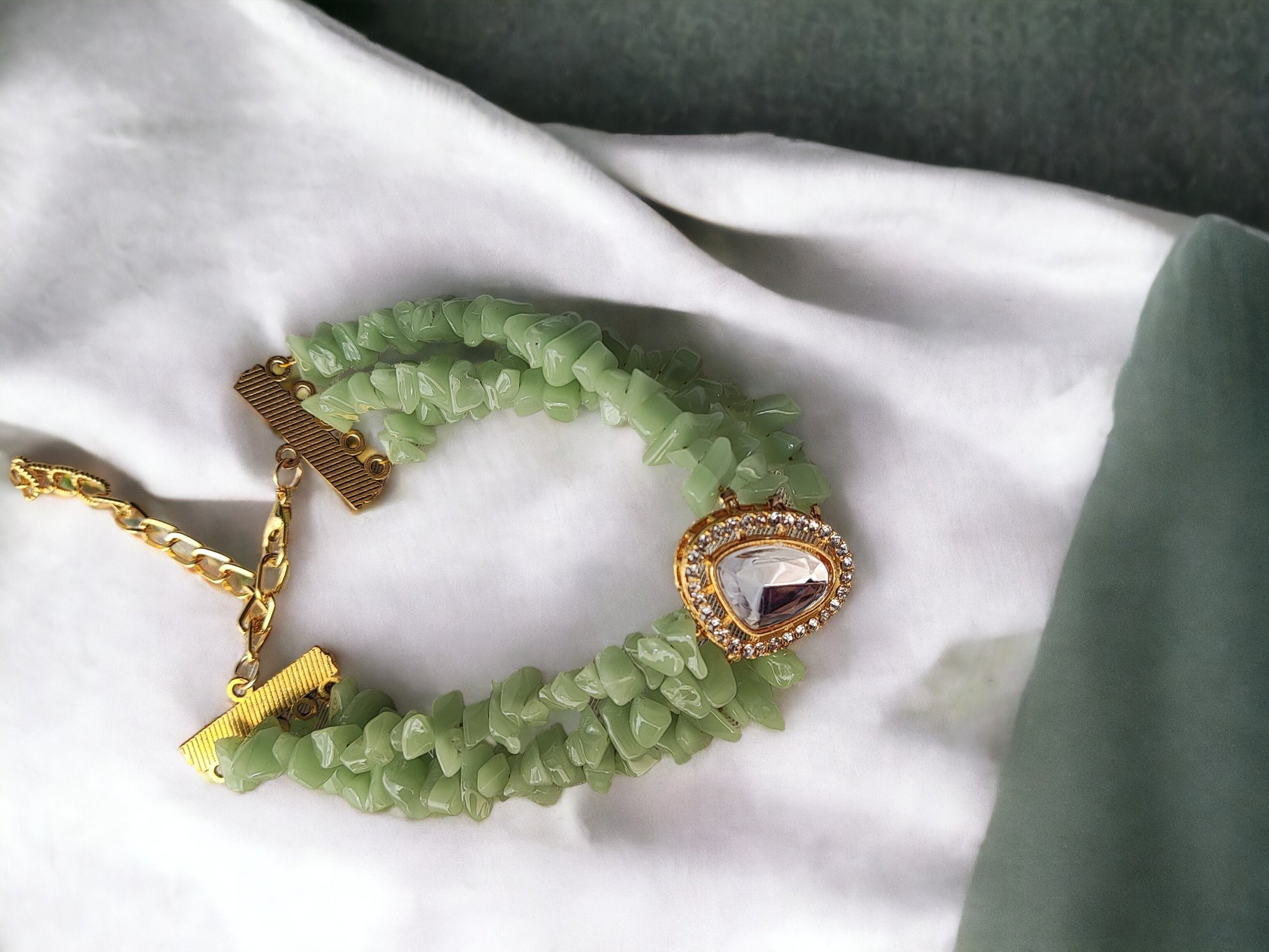 <p data-mce-fragment="1">This exclusive Green Beaded Bracelet is a handmade masterpiece, crafted with stunning chip and kundan beads. The adjustable hook ensures a perfect fit for any wrist. Elevate your style with this elegant and artfully designed bracelet.</p>