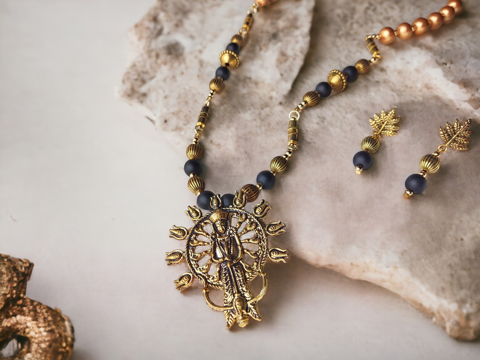 This jewelry set, titled Durga 4 in 1 style, is composed of metal components and embellished with Terracotta beads. Its versatility and ease of wear make it the perfect accessory for any occasion.