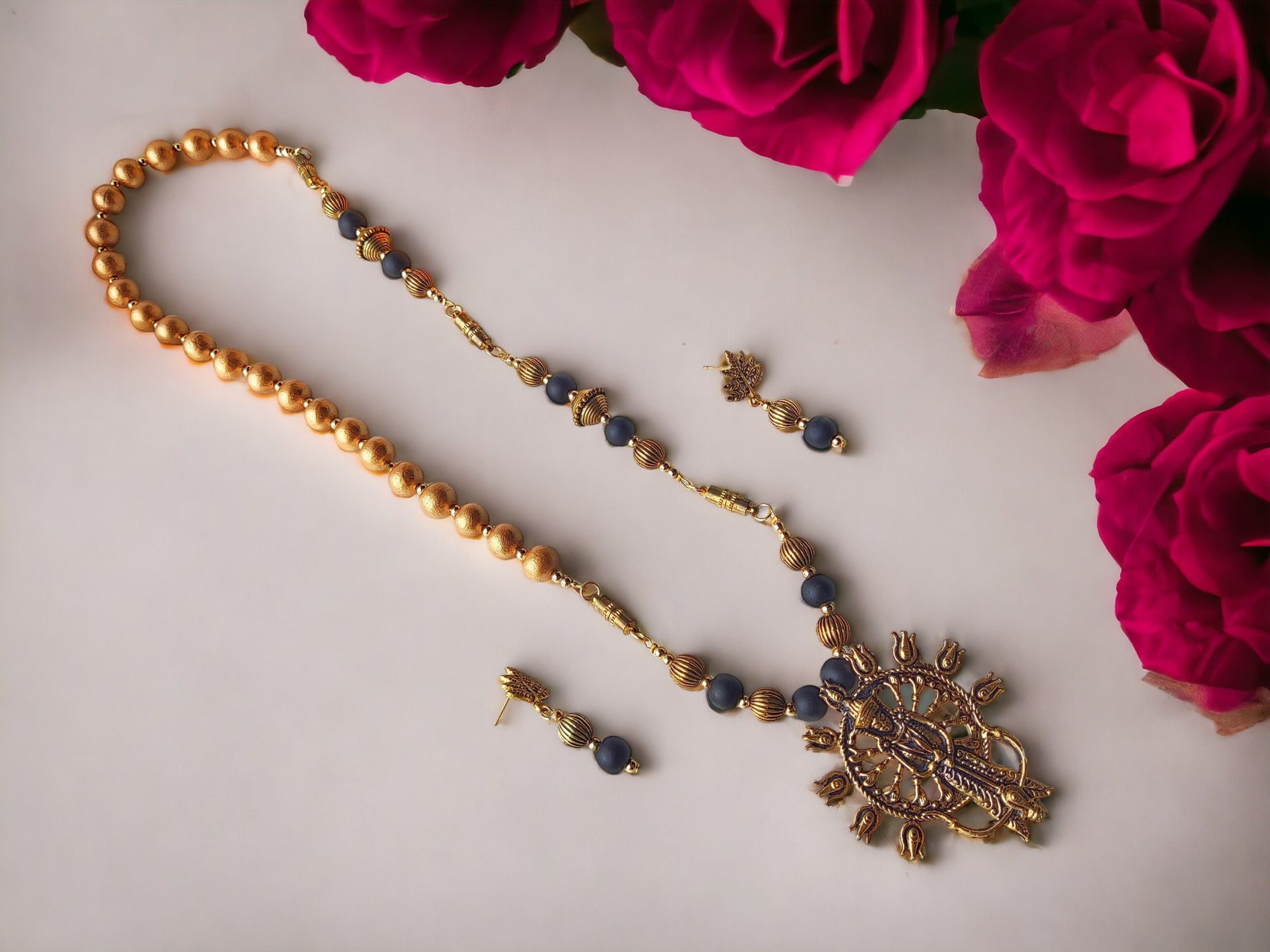This jewelry set, titled Durga 4 in 1 style, is composed of metal components and embellished with Terracotta beads. Its versatility and ease of wear make it the perfect accessory for any occasion.