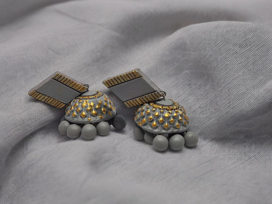 These grey terracotta earrings are crafted with precision and expertise, making them a perfect addition to any outfit. Made from high-quality materials, these earrings are designed to provide a sleek and stylish look while remaining durable and long-lasting. Elevate your style with these elegant earrings.