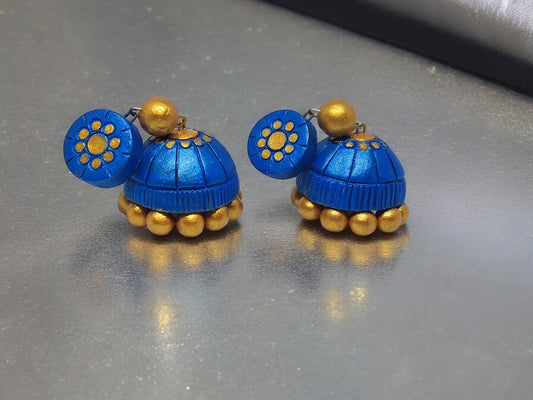 Add a touch of elegance to your outfit with these beautiful Royal Blue Terracotta Jhumka Earrings. Handcrafted with intricate detailing, these earrings are the perfect blend of traditional and modern styles. Made with high-quality materials, they are durable and lightweight, ensuring comfort and style all day long.