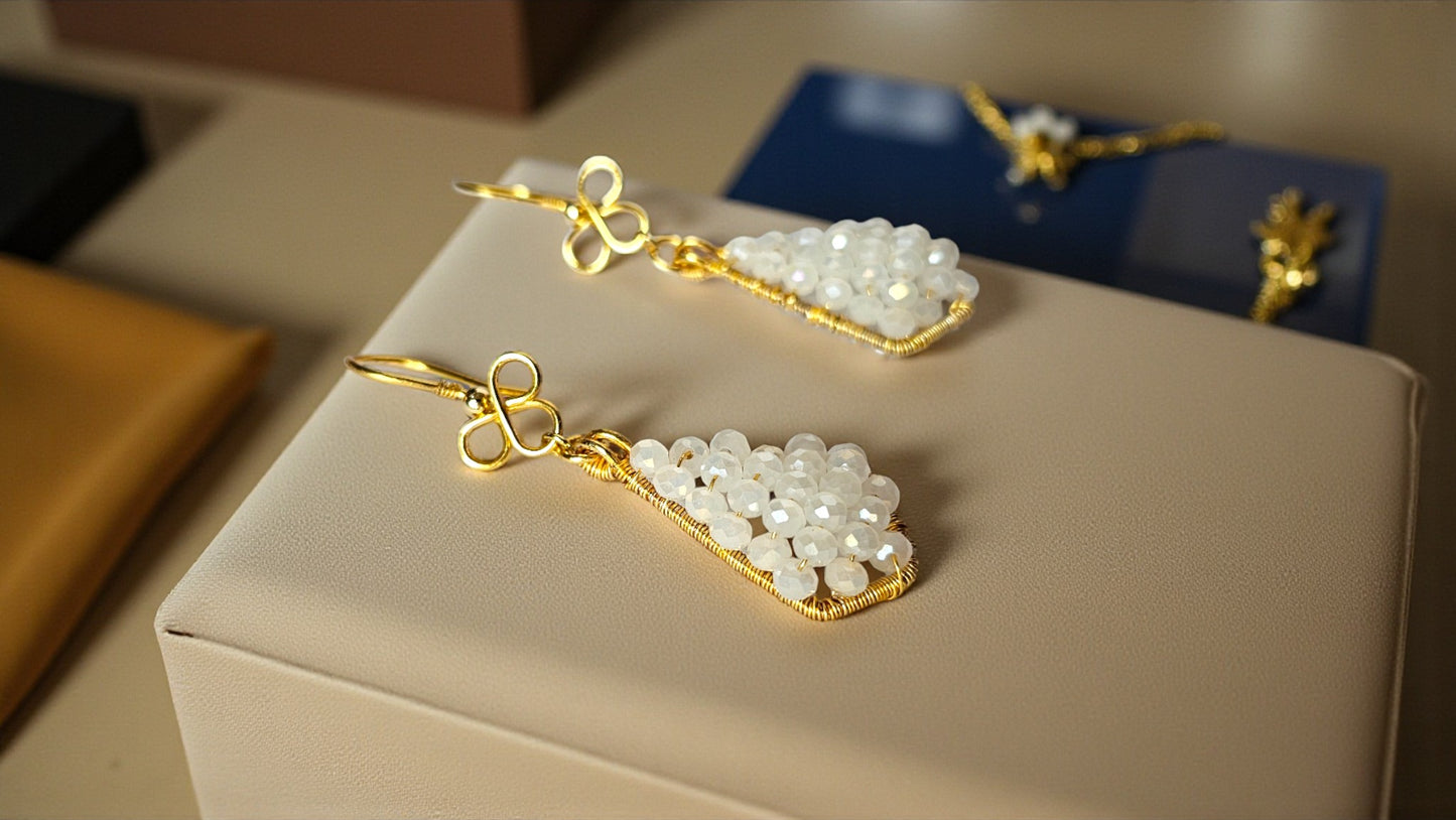 Aahana white bead wrap earrings with elegant gold accents and a unique design displayed on a neutral background