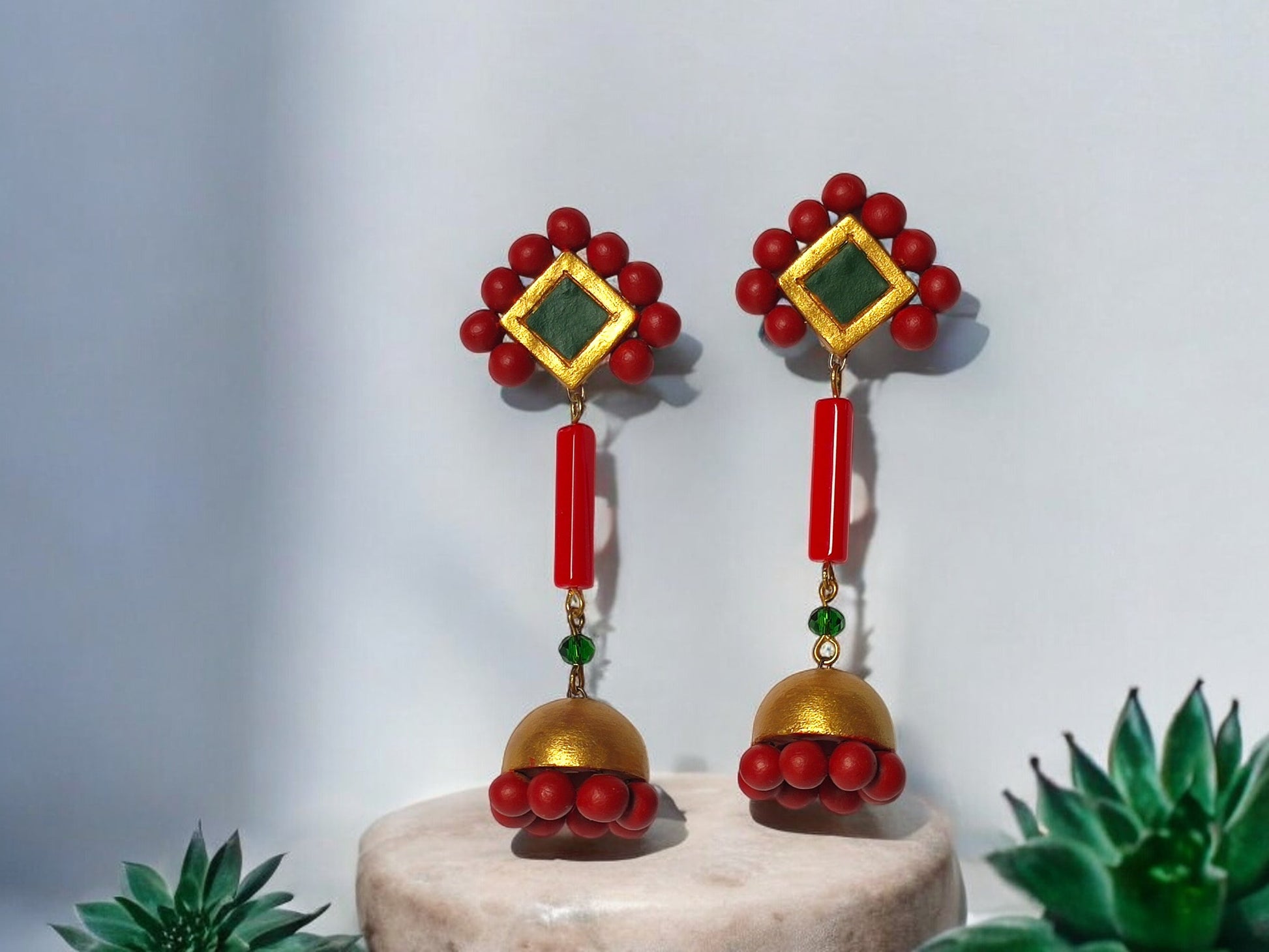 Abha statement dangle earrings by Anusangi Collections featuring red beads gold accents and terracotta elements