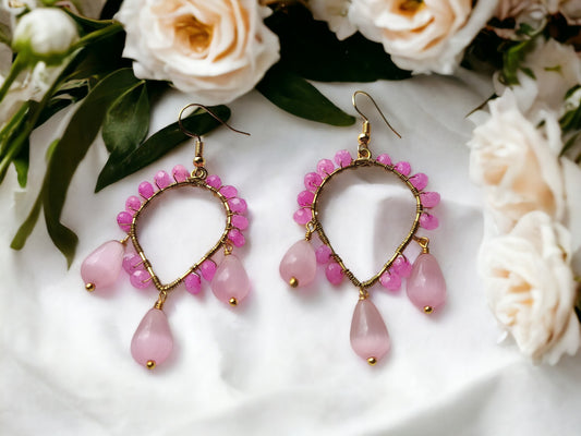 Pink agate bead wrap earrings from Anusangi Collections with gold accents and floral background