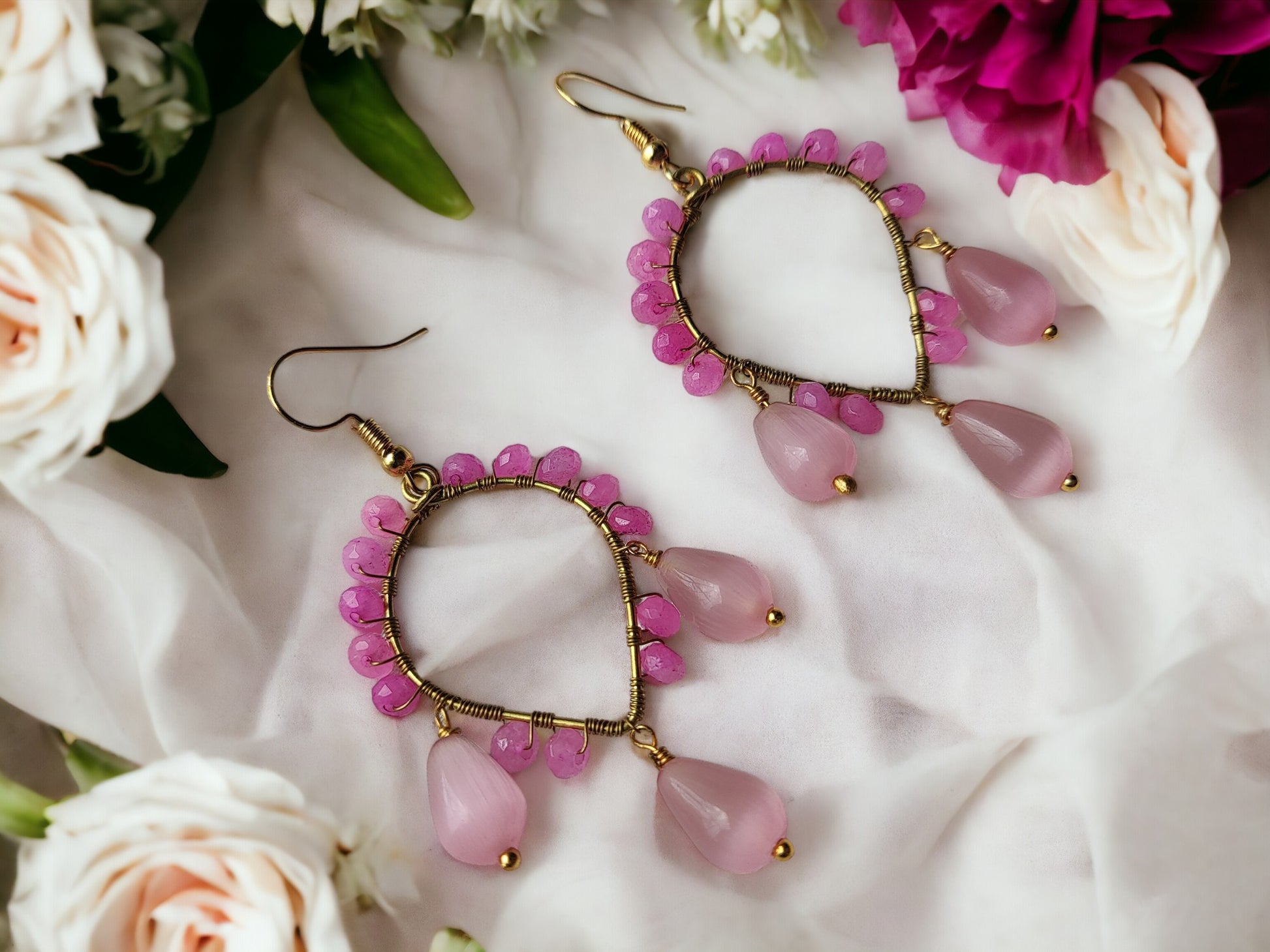 Anusangi Collections agate bead wrap earrings with pink beads and gold wire on white fabric background