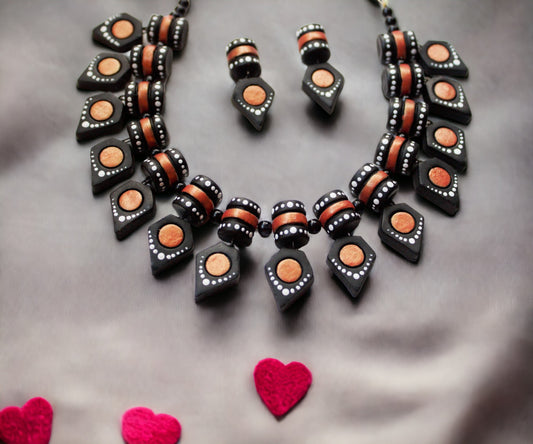 Black terracotta jewelry set from Anusangi Collections featuring necklace and matching earrings