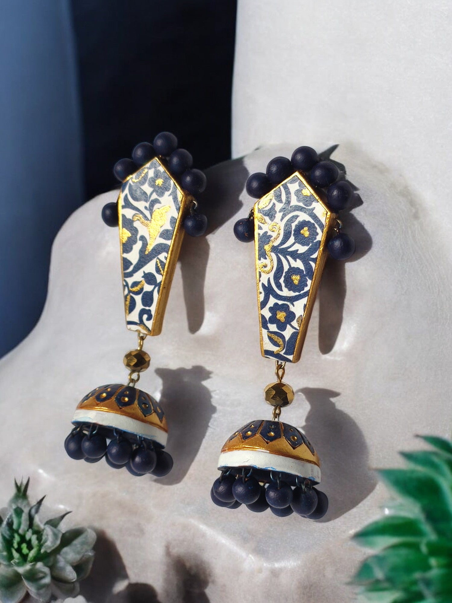 Blue and gold ethnic terracotta earrings with intricate floral design and bead accents by Anusangi Collections