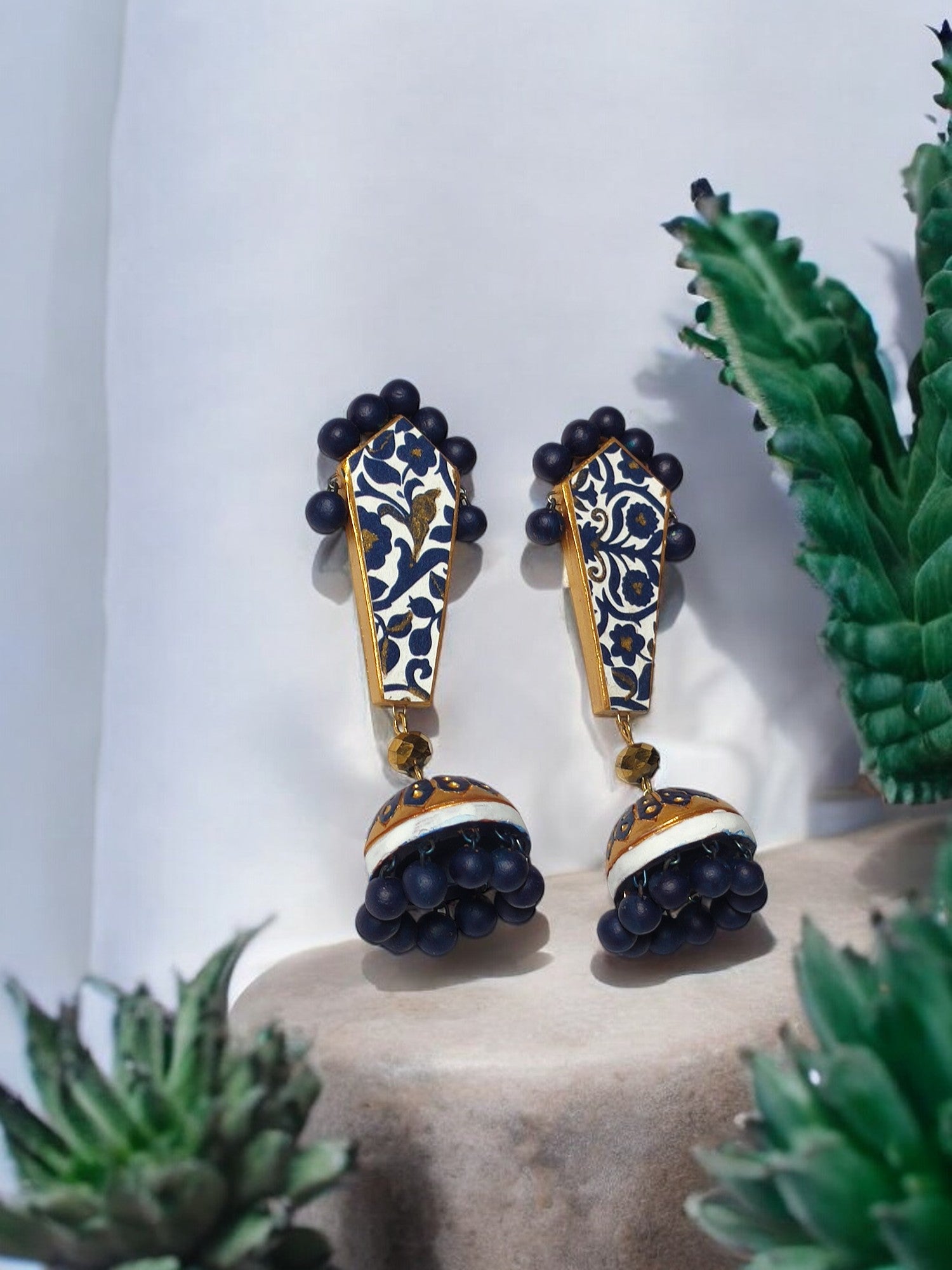Blue and gold ethnic terracotta earrings with intricate floral design and bead embellishments from Anusangi Collections