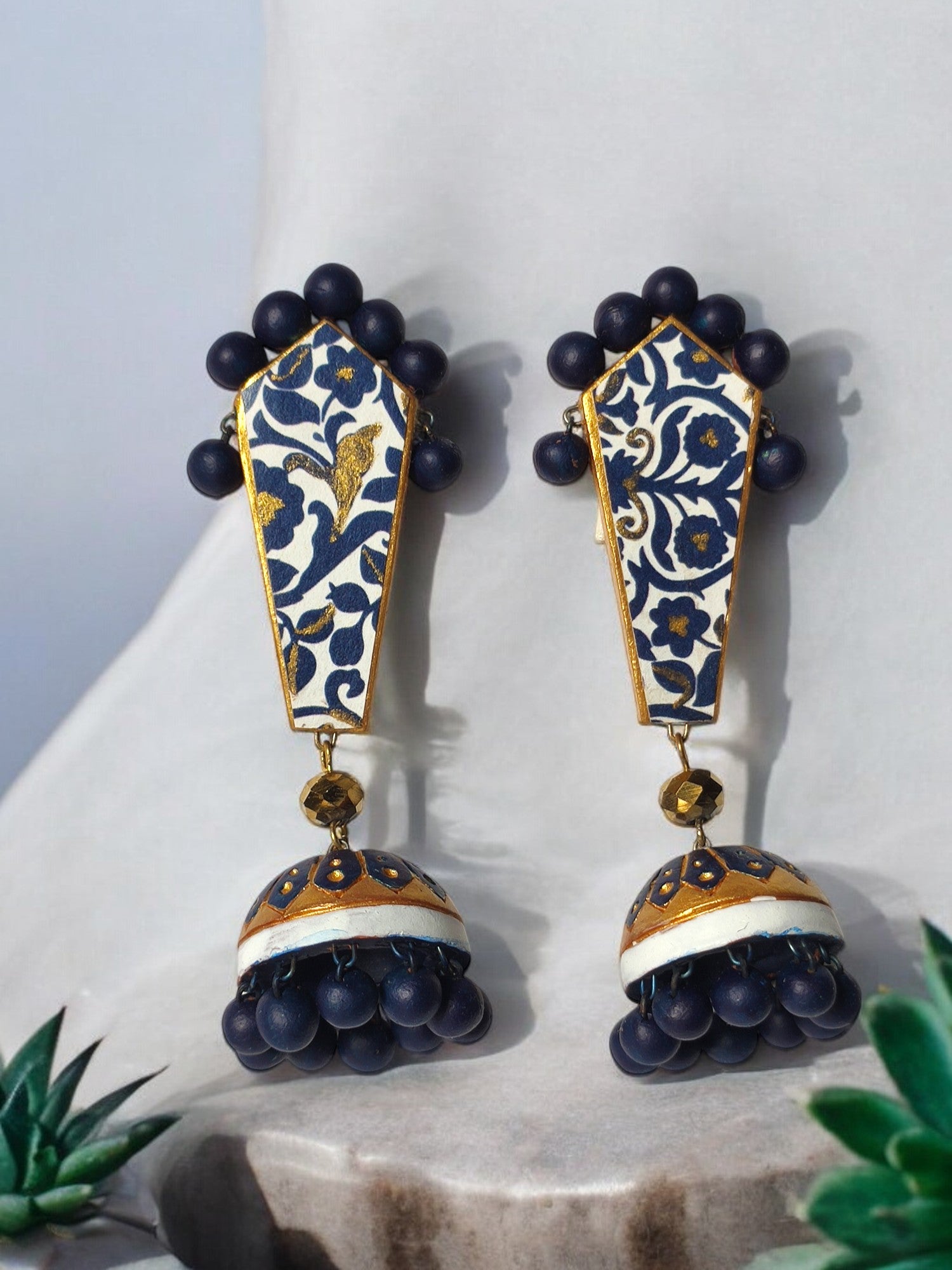 Blue and gold ethnic terracotta earrings from Anusangi Collections with intricate floral design