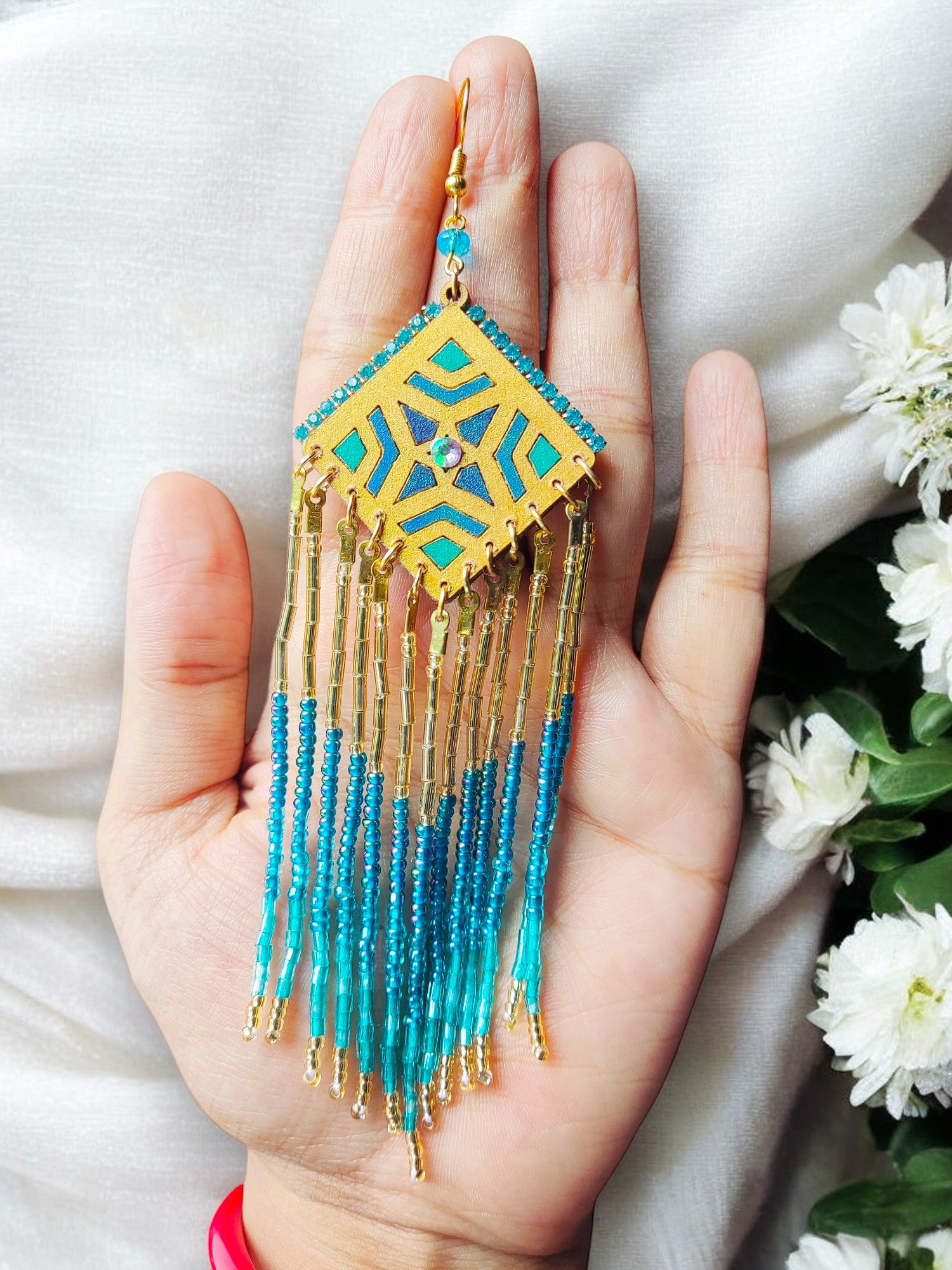 Boho statement beaded earrings with gold and blue geometric design and long dangling beads