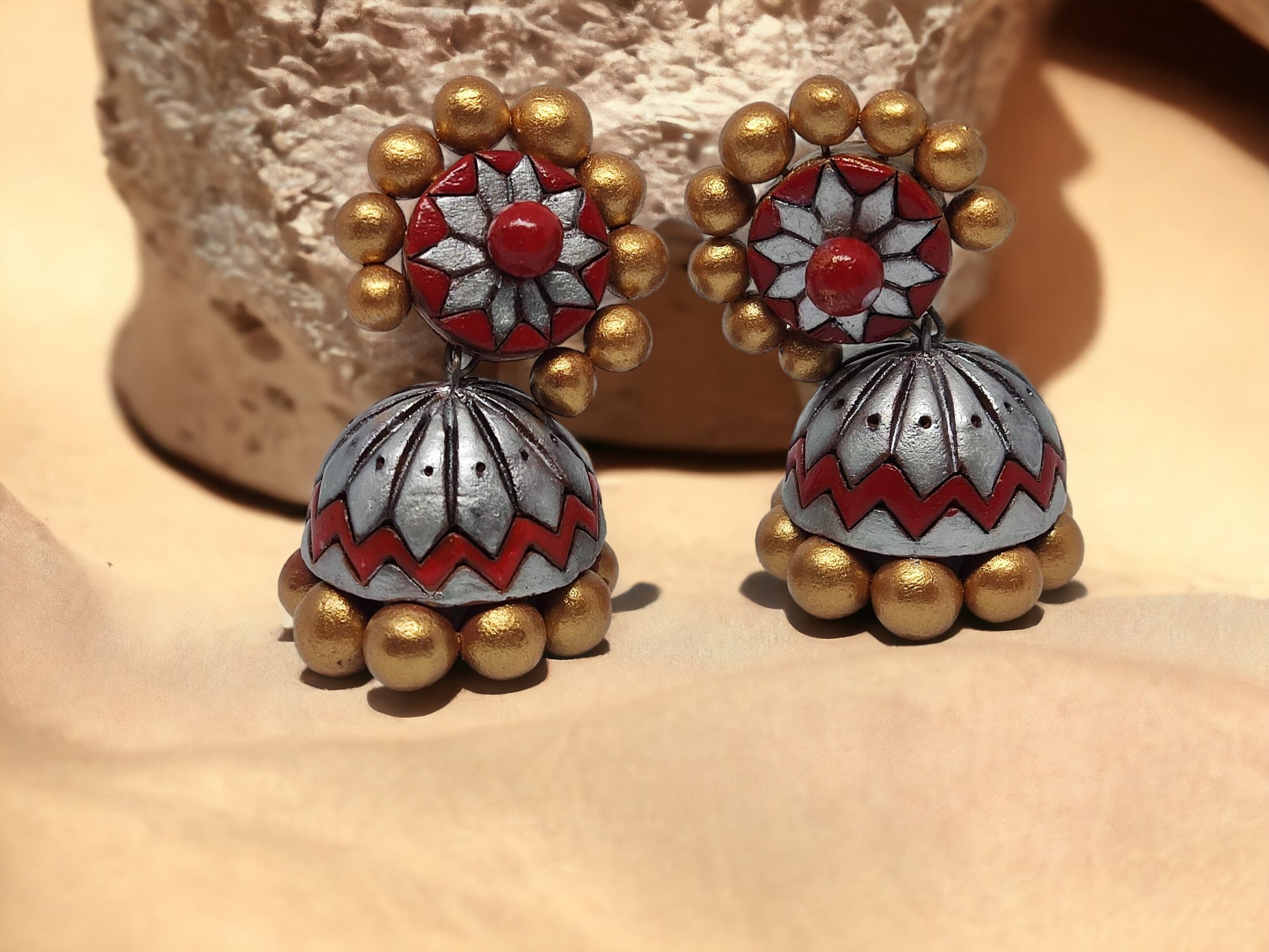 Buy traditional Jhumka terracotta earrings in red and gold with floral and bead design from Anusangi Collections