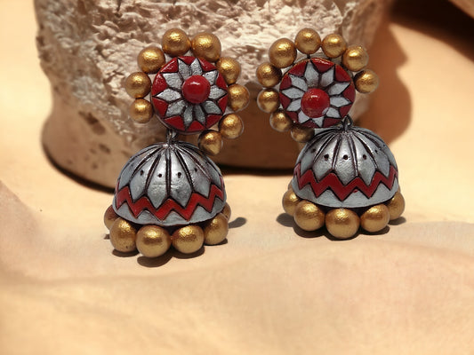 Buy traditional Jhumka terracotta earrings in red and gold with floral and bead design from Anusangi Collections