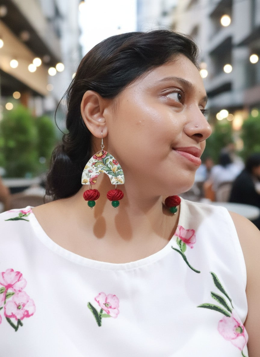 Floral statement earrings handmade from Anusangi Collections worn by a woman in a sunny setting