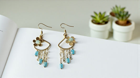 Gold earrings with floral designs and turquoise beads featuring delicate dangles for a stylish look
