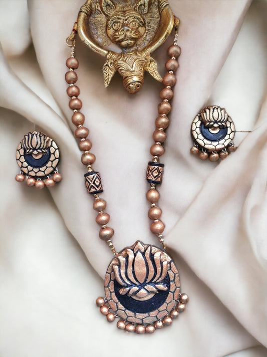 Anusangi Collections terracotta jewelry set featuring a golden lotus necklace for women with matching earrings