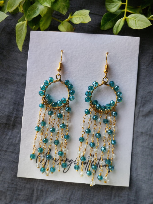 Anusangi Collections handmade beaded earrings with blue beads and gold chains on white card
