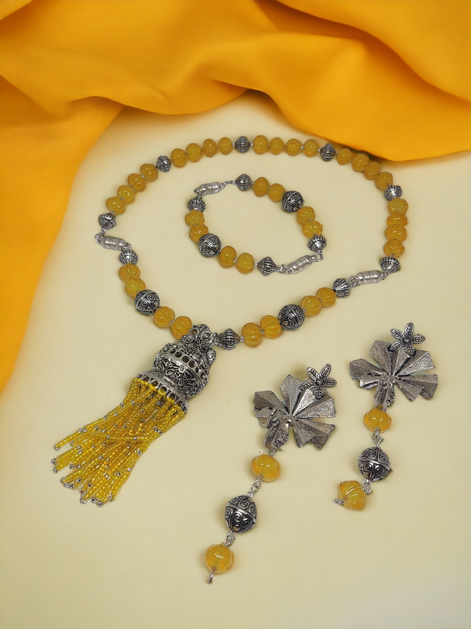 Handmade beaded jewelry set with yellow beads and silver floral accents from Anusangi Collections