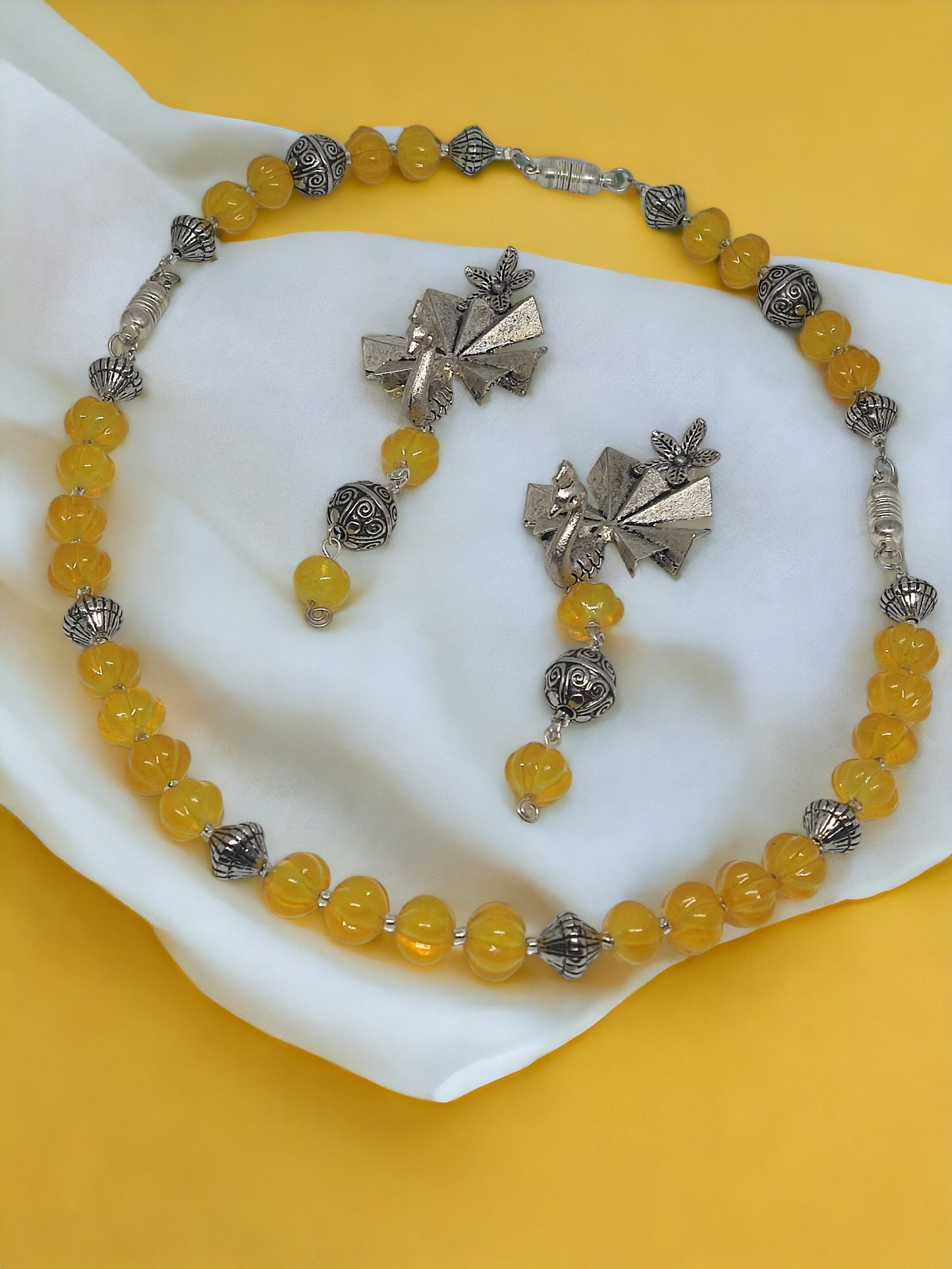 Handmade beaded jewelry set with yellow beads and silver decorative elements from Anusangi Collections