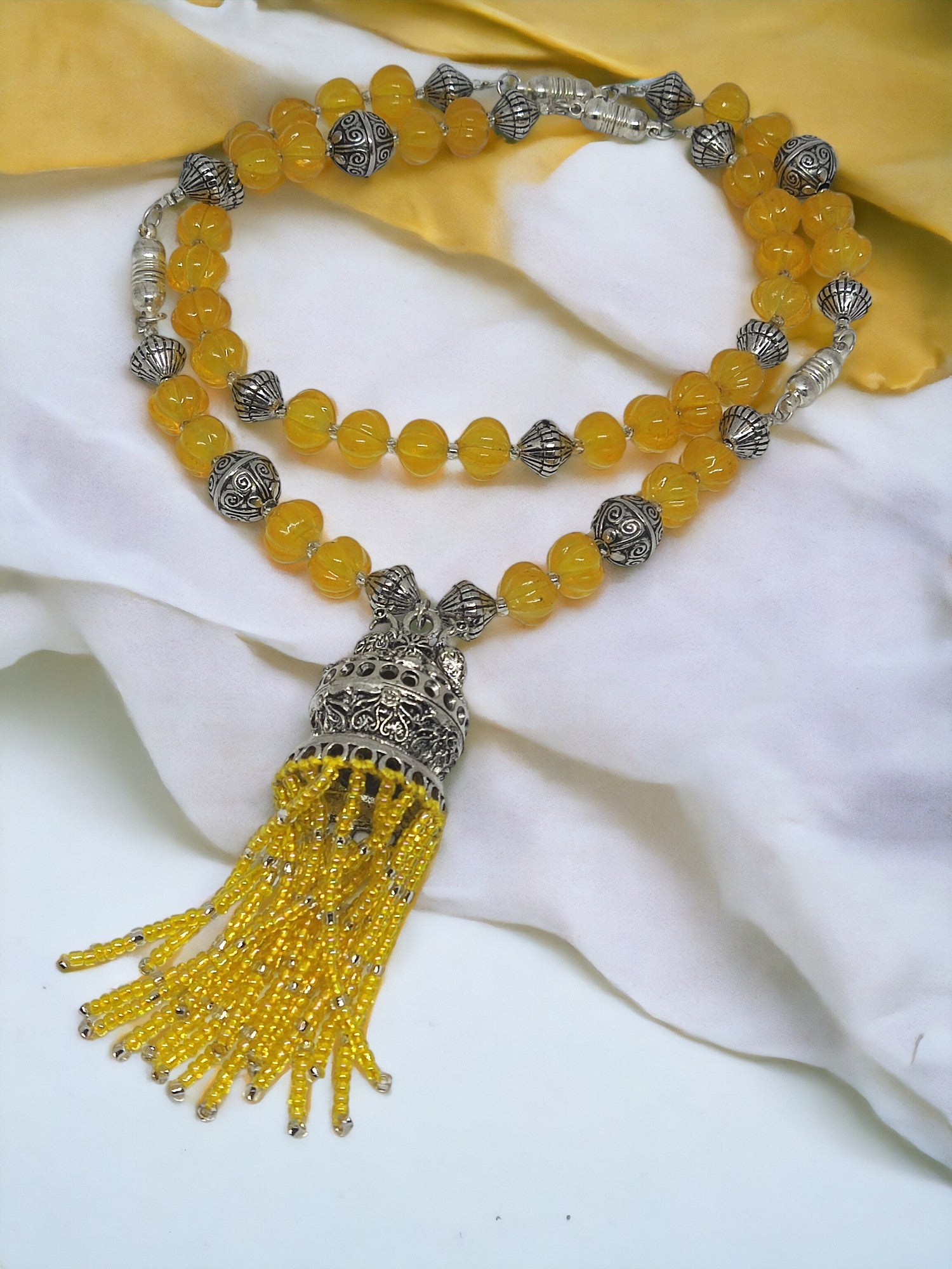 Anusangi Collections handmade beaded jewelry set with yellow beads and silver ornate pendant tassel