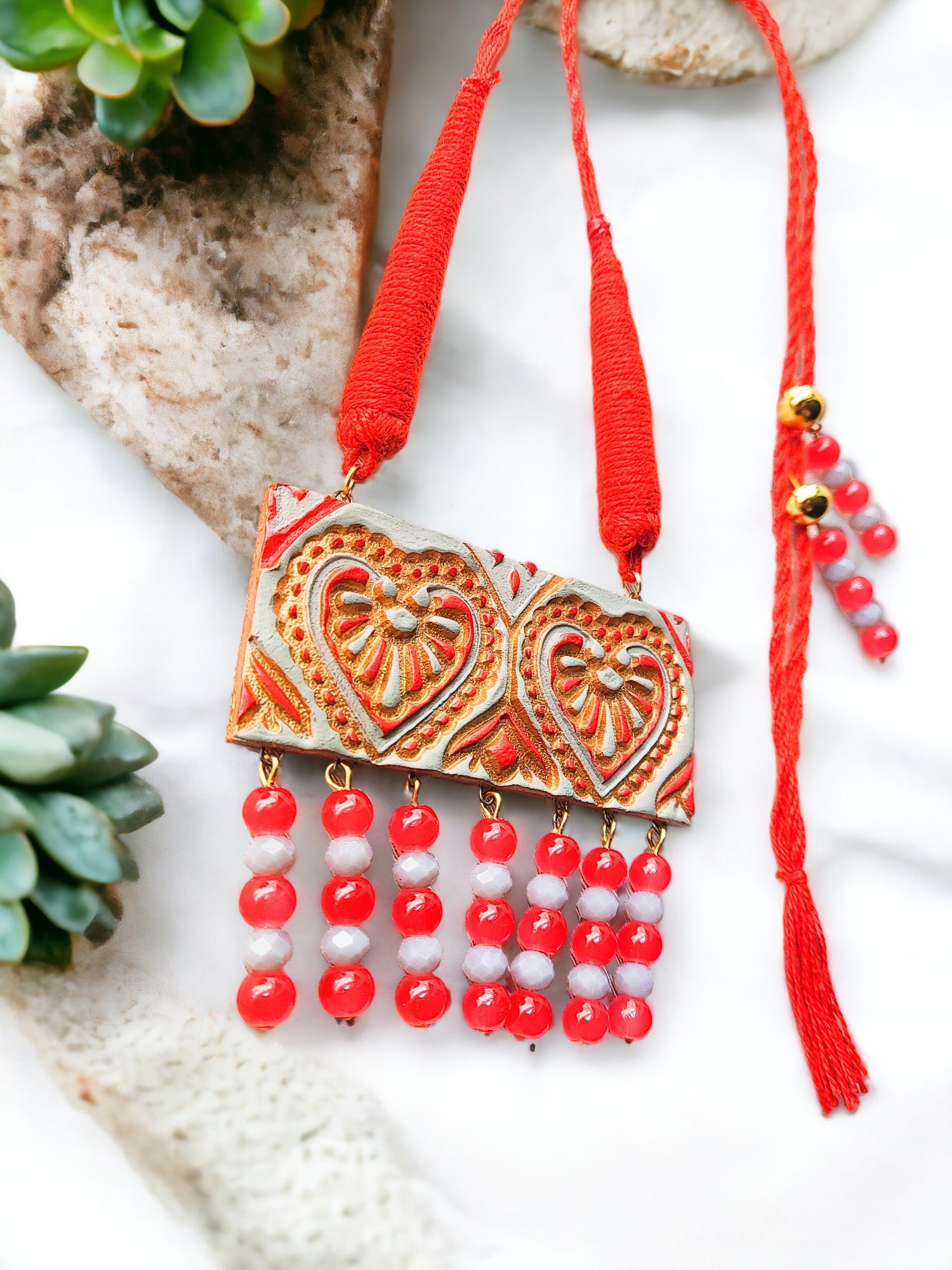 Anusangi Collections heart motif terracotta jewelry set with red and white beads and intricate design