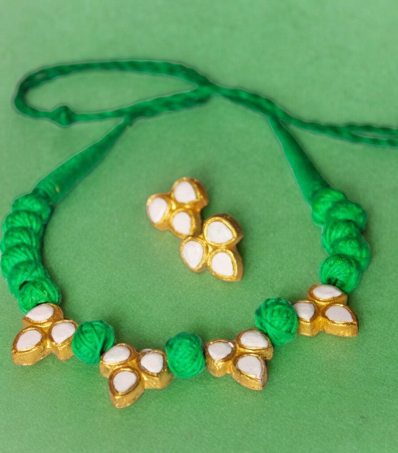 Handcrafted from high-quality terracotta, this necklace set features a stunning ivory and green color palette. The carefully sculpted beads and intricate details make it a unique addition to any jewelry collection. Elevate your outfit with this elegant and timeless piece.