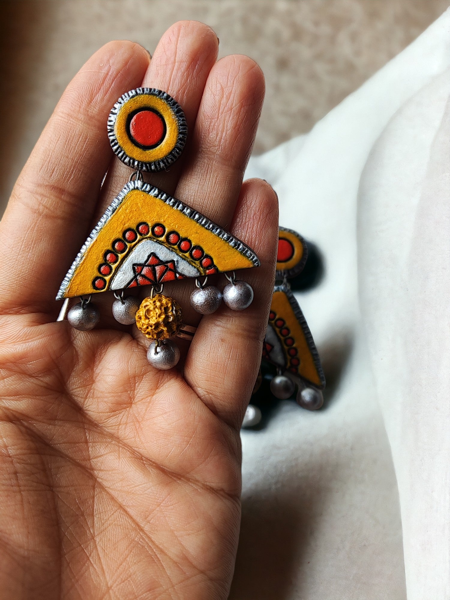 Kasturi terracotta jewelry yellow and orange terracotta earring with silver bead accents by Anusangi Collections