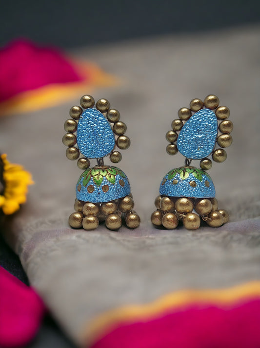 Blue and gold Lakshita terracotta jhumka earrings from Anusangi Collections with intricate detailing