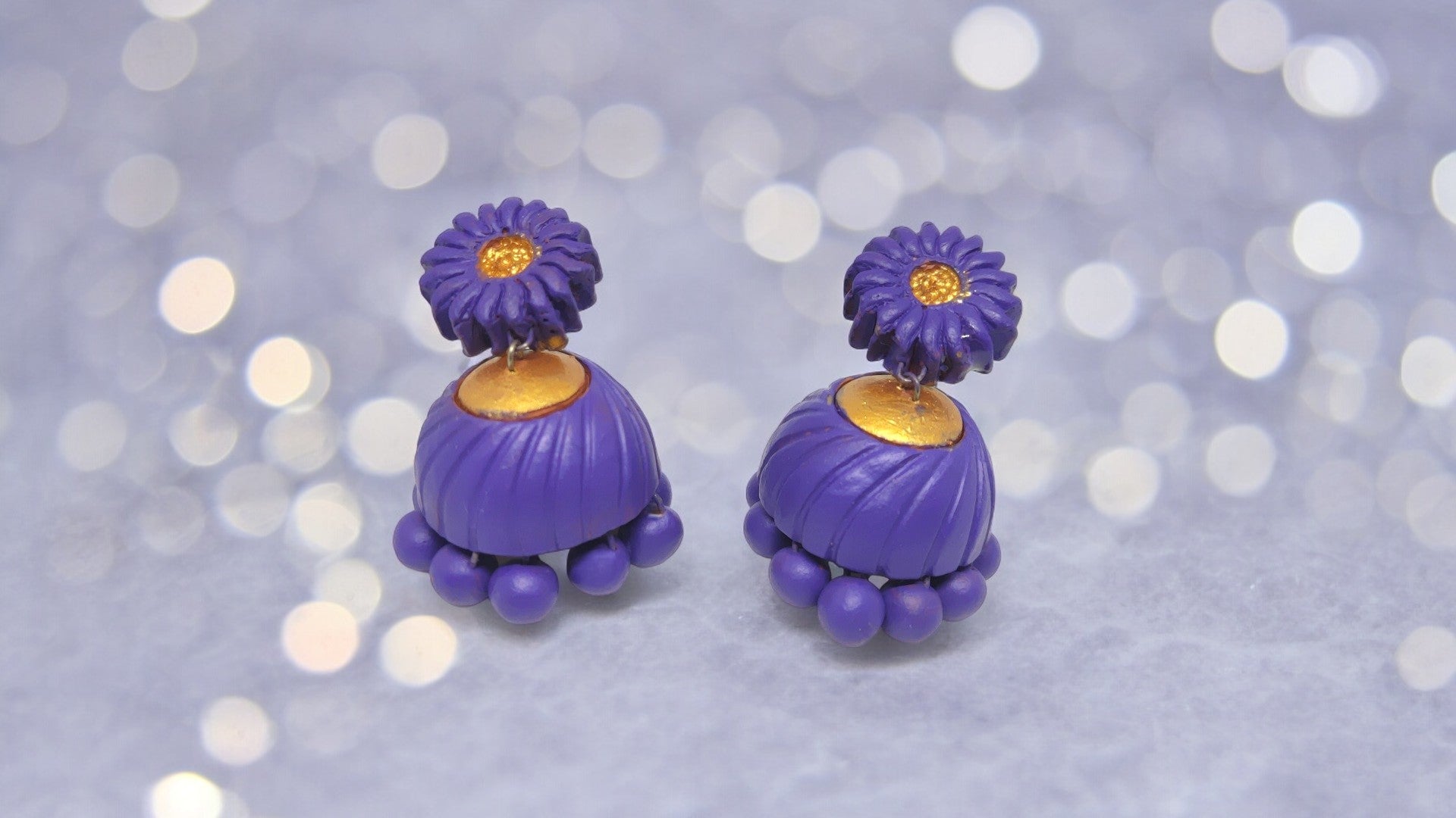 Lavender terracotta earrings with flower design and gold accents from Anusangi Collections