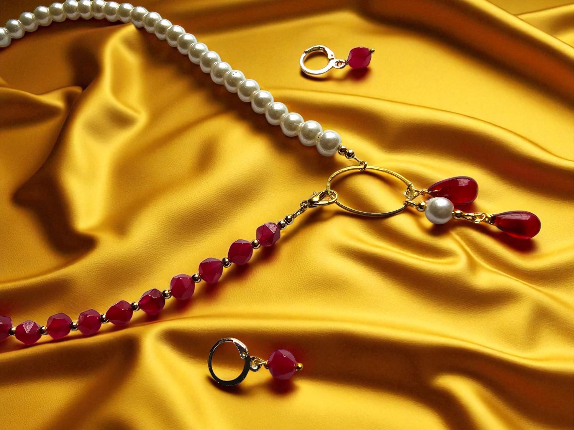 Elegant maroon and pearl jewelry set featuring a beaded necklace and matching earrings on a yellow background