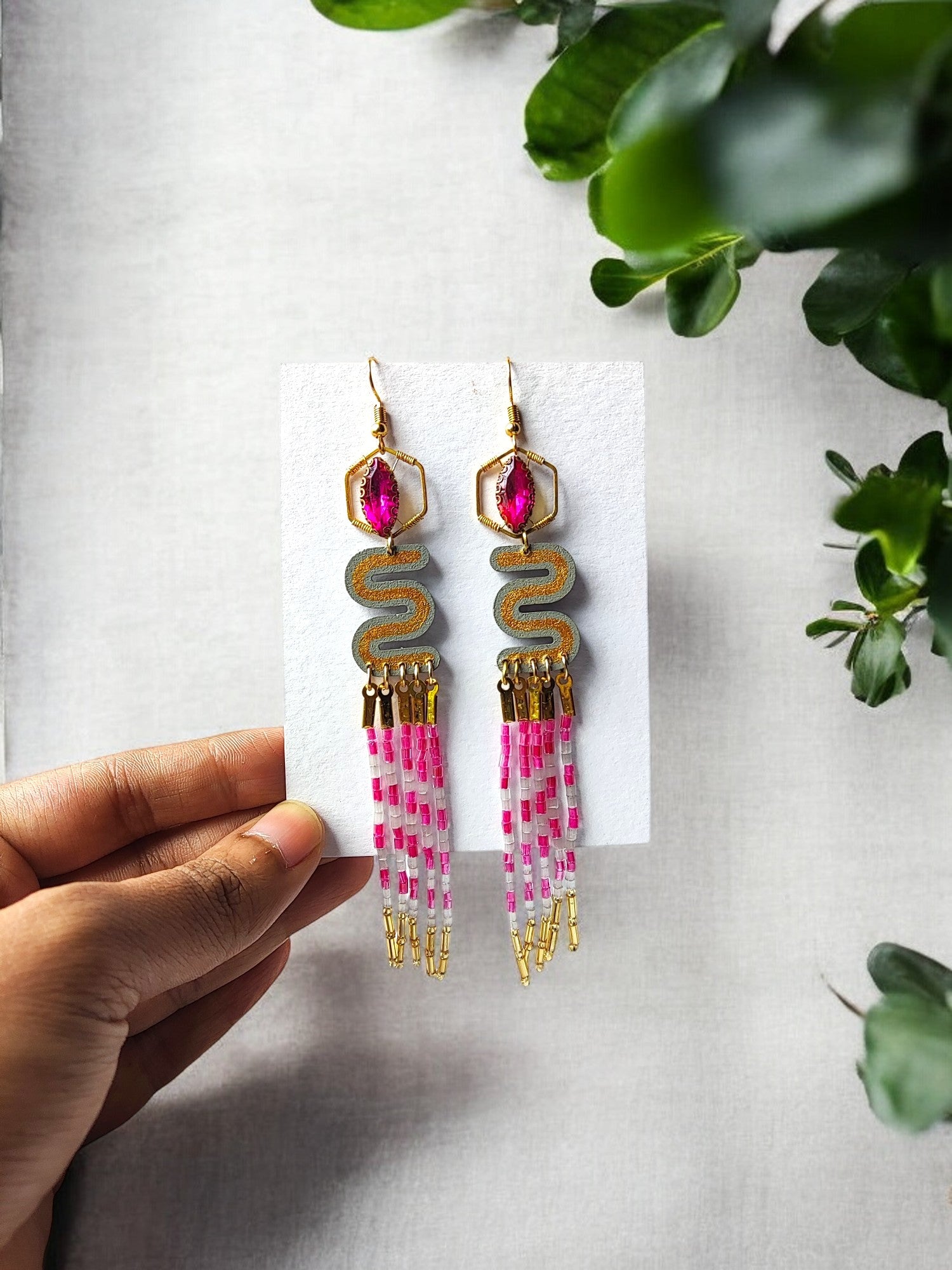 Anusangi Collections pink and gold dangle earrings with intricate beading and fringe design