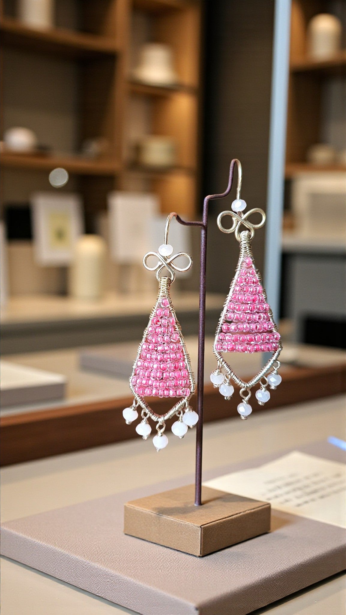 Rosy Ribbon Dangles beaded earrings from Anusangi Collections featuring pink triangular design with white accents