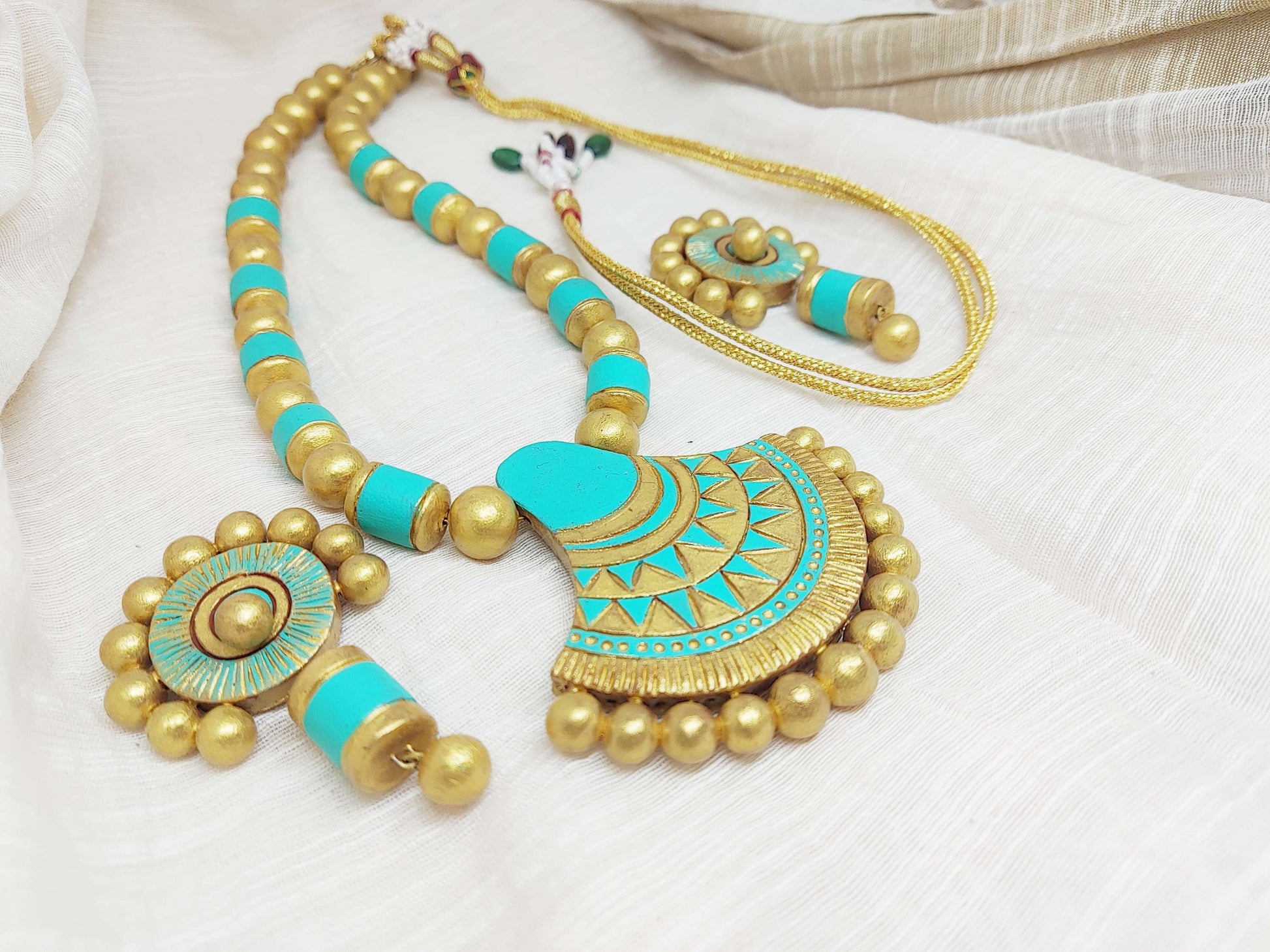 Anusangi Collections sea green terracotta jewelry set with necklace and earrings in intricate gold and turquoise design