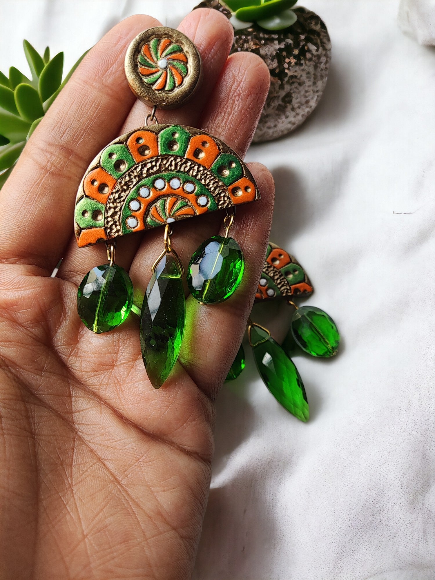 Shakuntala terracotta earrings by Anusangi Collections with green and orange design and hanging green beads