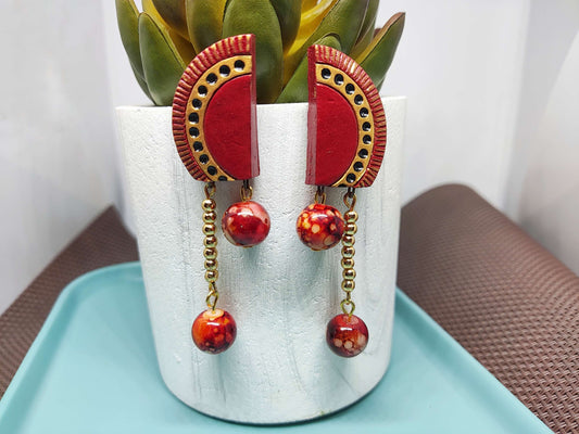 Red and gold statement terracotta earrings with dangling beads from Anusangi Collections