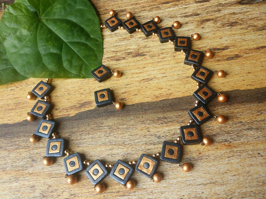 Terracotta necklace set online from Anusangi Collections featuring square black and brown beads with gold accents