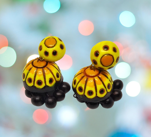 Colorful yellow and black Titli terracotta jhumka earrings from Anusangi Collections with intricate design