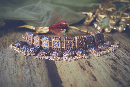 Terracotta jewelry set featuring traditional fabric choker necklace with intricate designs and pearl accents by Anusangi Collections