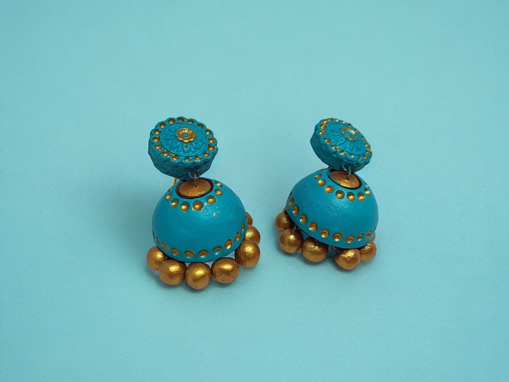 Turquoise blue terracotta earrings with golden bead detailing from Anusangi Collections