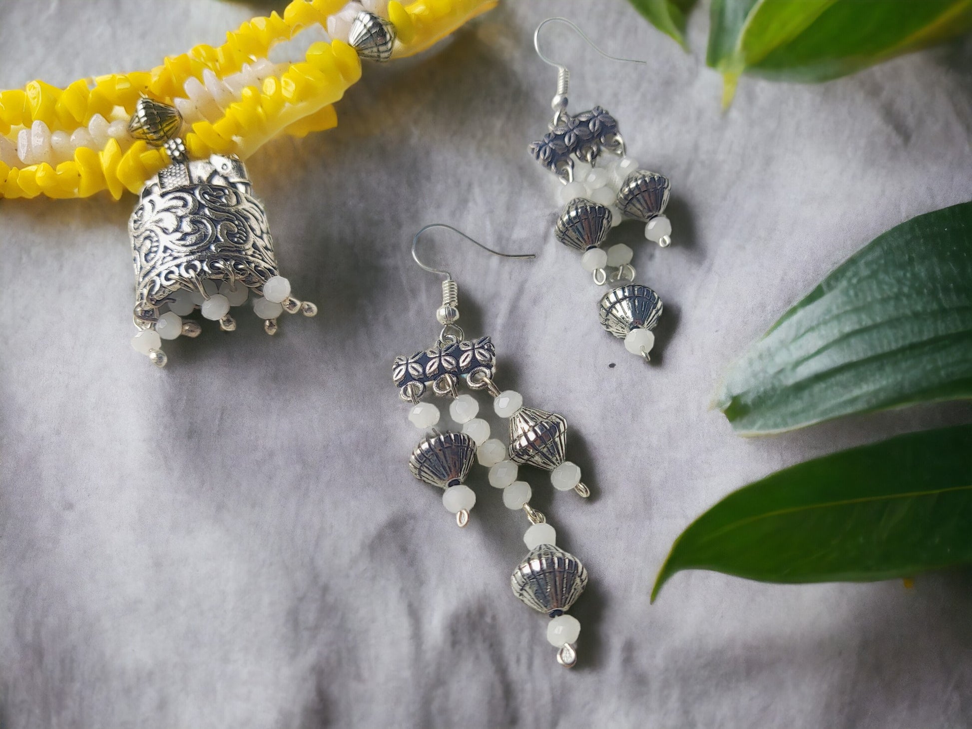 Anusangi Collections uncut beaded choker necklace set with yellow beads and silver jhumka earrings